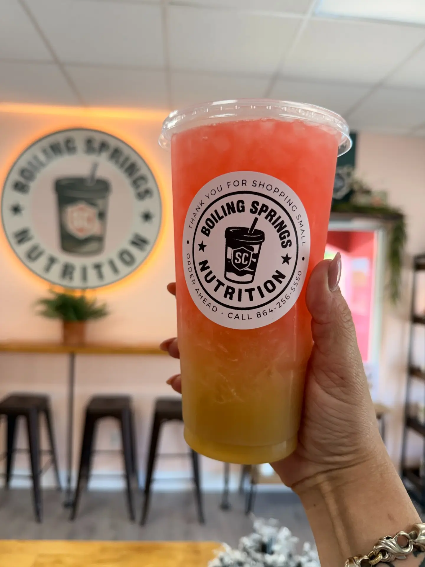 A fresh BSN drink held up inside the Boiling Springs Nutrition shop